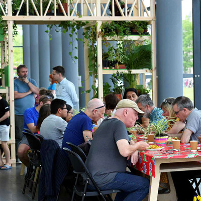 People enjoying food and socializing during an event at MIMA (Middlesbrough Institute of Modern Art)