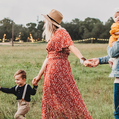 Family with three children walking together in a forest, enjoying nature