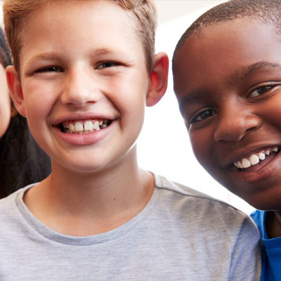 Group of ethnically diverse children standing together and smiling