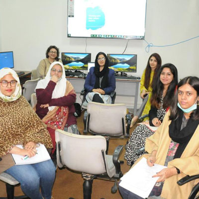 Pakistani women engaged in discussion, representing the voices of South Asian women writers and early career researchers overcoming barriers
