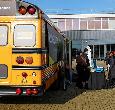 Students exploring the Yellow Bus during a Teesside University open day event