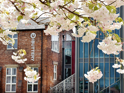 Photograph of The Buttery, with blossom in the foreground  (The Buttery is our dedicated PG space). Link to Photograph of The Buttery, with blossom in the foreground  (The Buttery is our dedicated PG space).