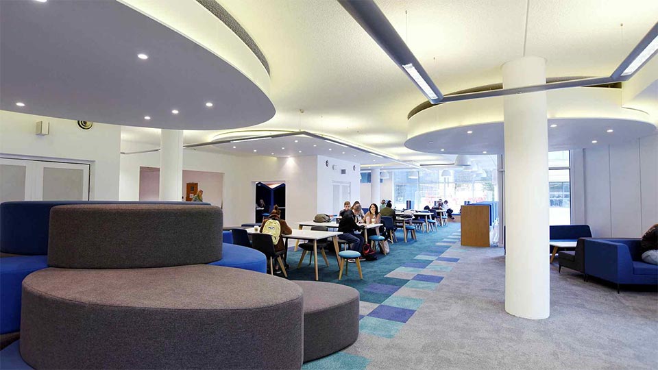 Ground floor of the Teesside University Library with study spaces and students