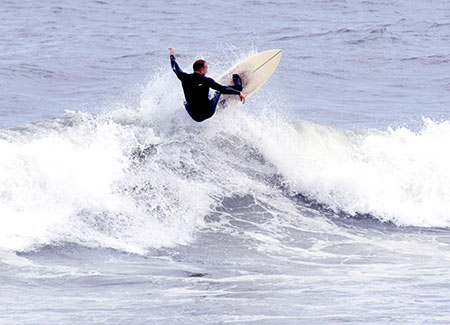 Man surfing in the sea at Saltburn-by-the-Sea