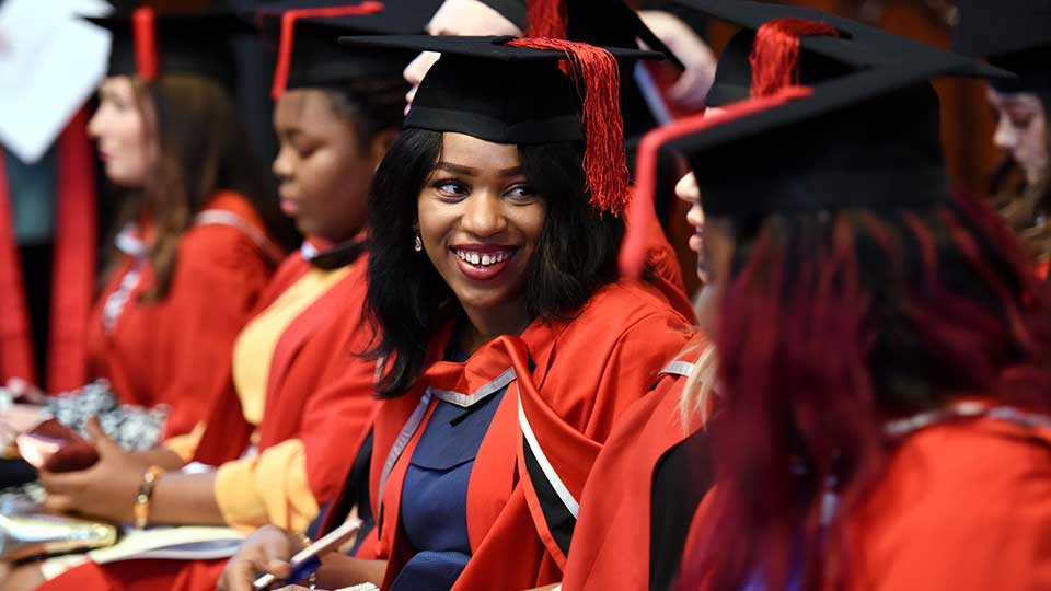 Graduated students celebrating together at a Teesside University graduation event.