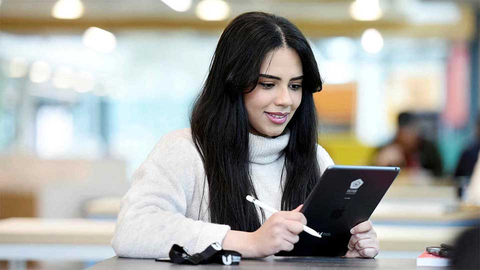 Student using an iPad on campus at Teesside University