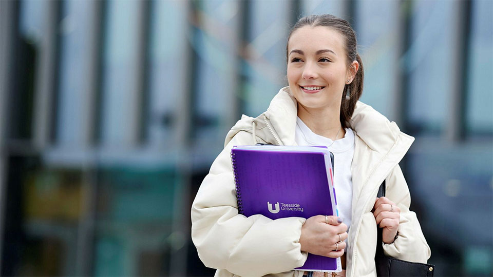 Student walking through the Campus Heart at Teesside University