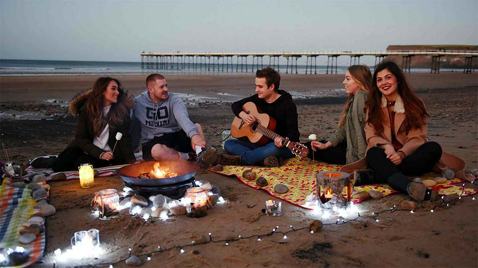 Teesside University students enjoying a day at the Saltburn beach