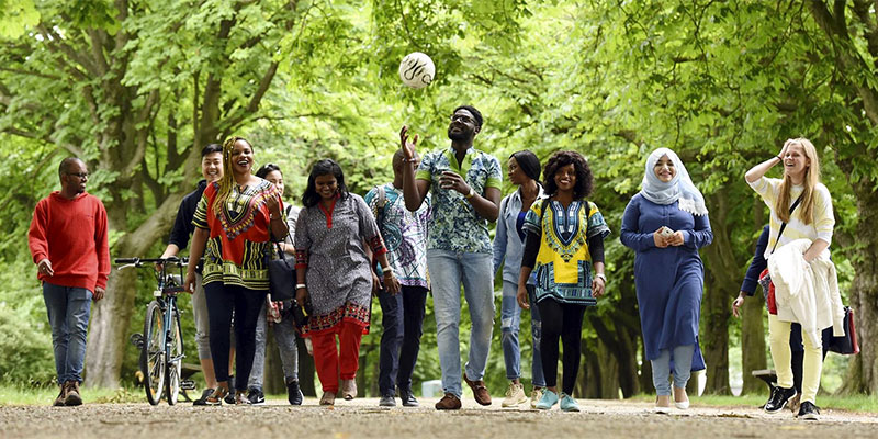 international students walking in the park