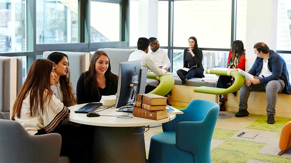 Group of students studying and collaborating in Teesside University library
