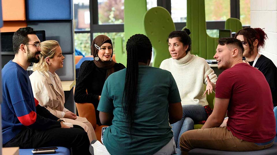 Group of Teesside University students studying together in the library