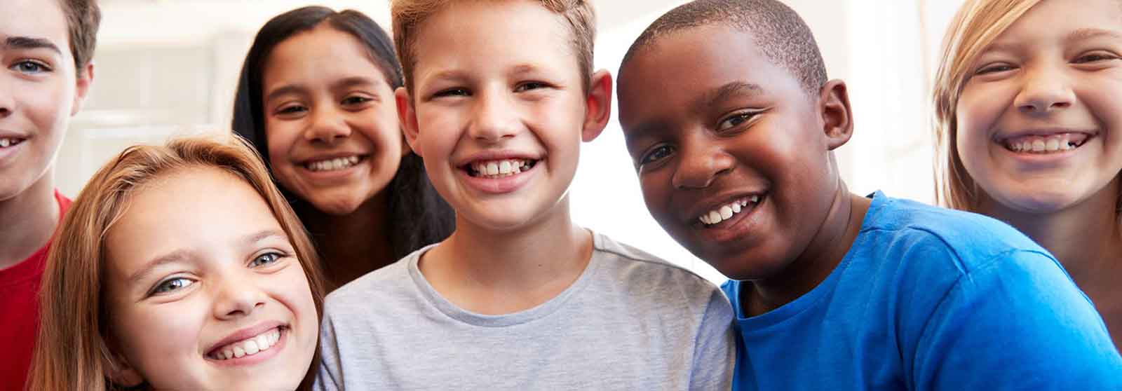 Group of ethnically diverse children standing together and smiling