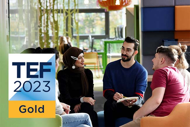 Teesside University students sitting and talking on campus