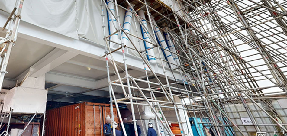 Temporary access and metal staircase made from staging and scaffolding the construction site.