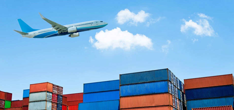 Airplane flying over a harbor of ships