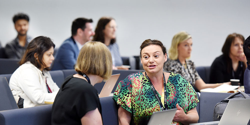 Teachers and advisers speaking with parents at a Teesside University event