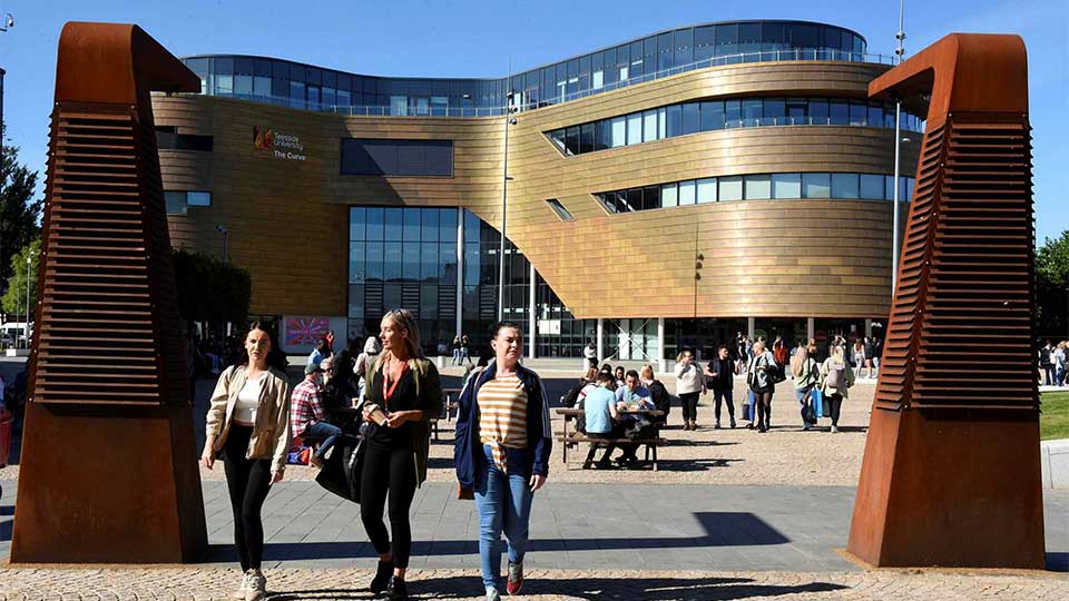 The Curve building with students walking across Teesside University campus