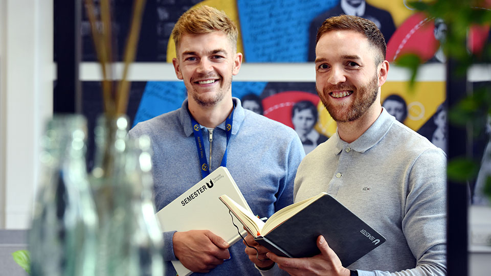 Two graduate entrepreneurs from Teesside University discussing at an alumni event.