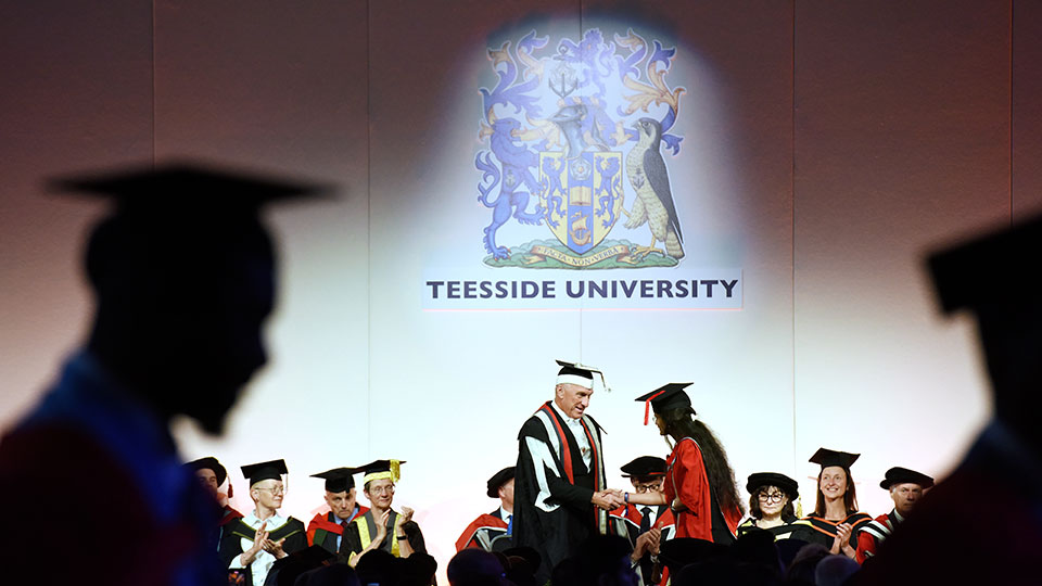 Teesside University Vice-Chancellor Professor Paul Croney OBE congratulating a graduate during the graduation ceremony.