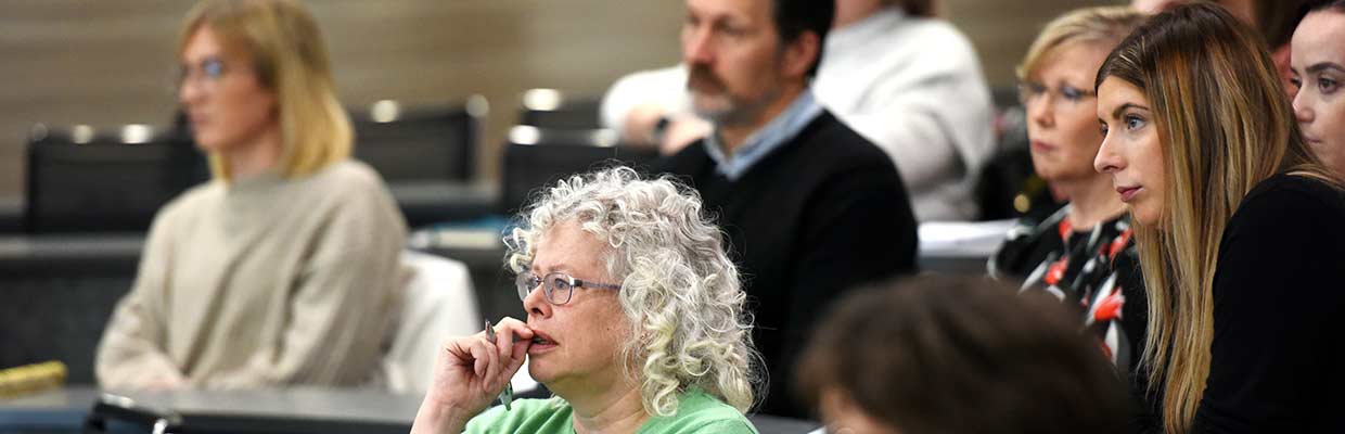 People attending a leadership and management event, engaged in discussion
