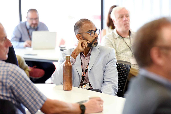 Conference attendees seated and listening during an event at Teesside University