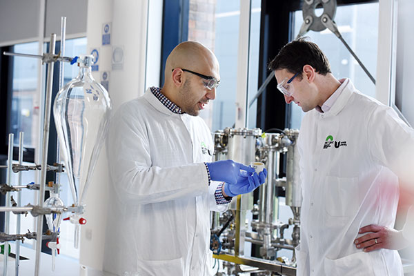 University staff collaborating in a research lab at Teesside University