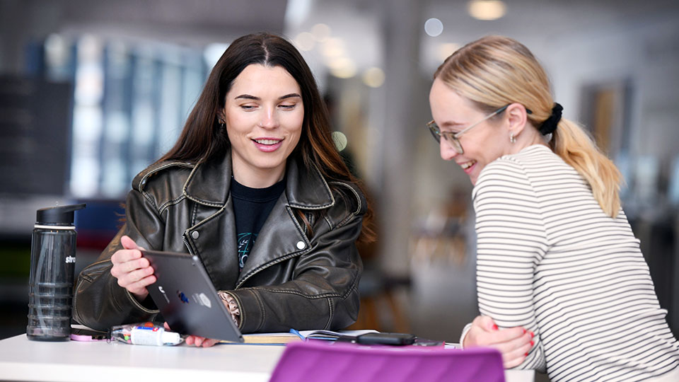 Students sit at the library coffee shop