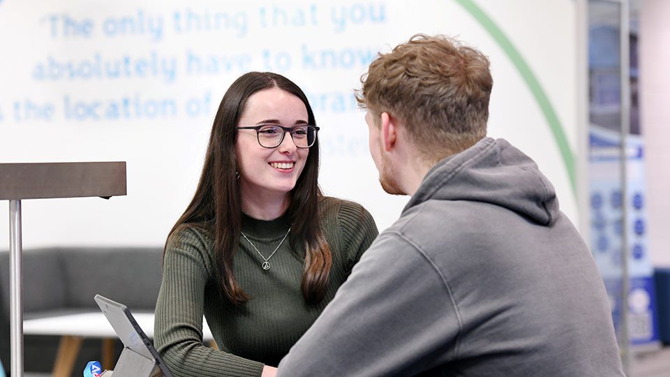students talking while sitting at a table