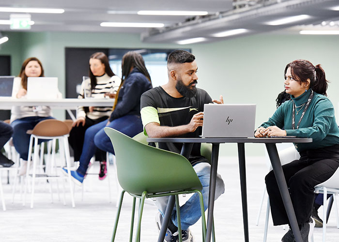 Students speaking with a staff member at Teesside University London